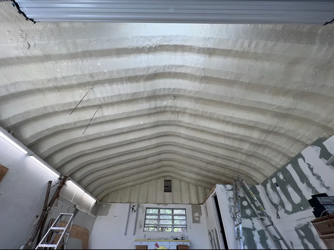 Spray polyurethane foam applied to the underside of a metal roof deck in Asbury Lake